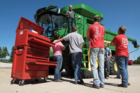 Students and John Deere combine